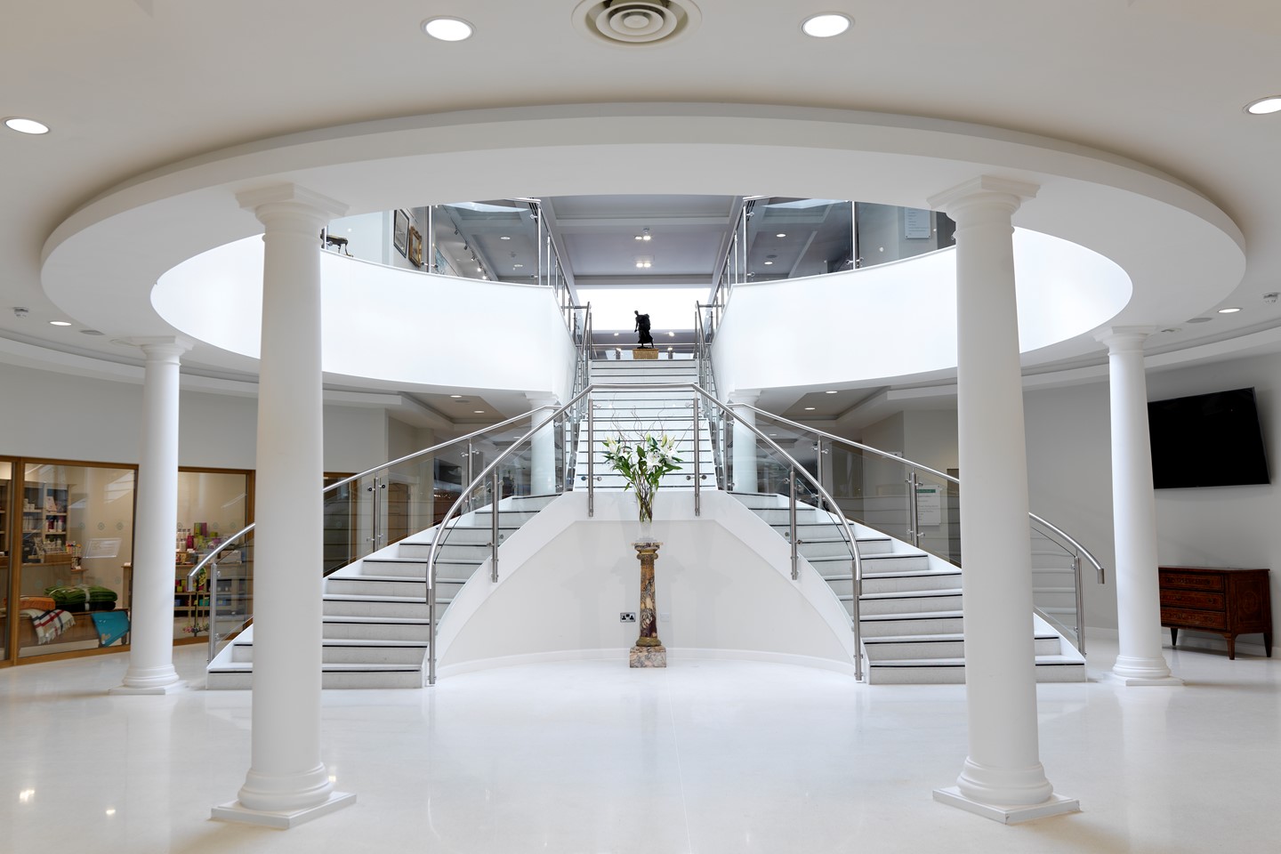 Garden Rooms entrance in the reception area, with the double staircase and white pillars